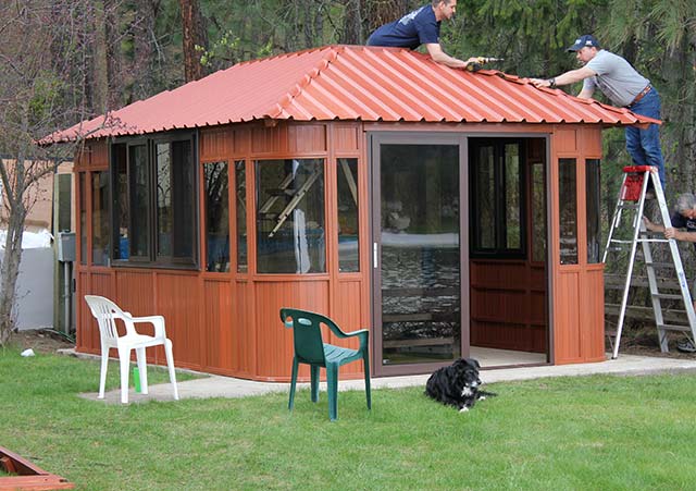 men installing a gazebo roof